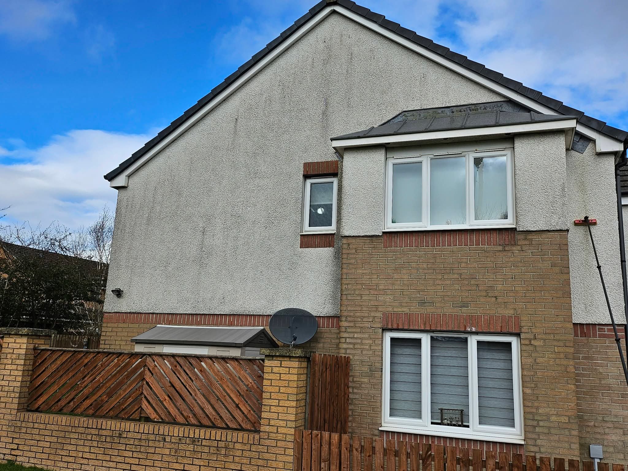 Render softwashing on gable wall — before